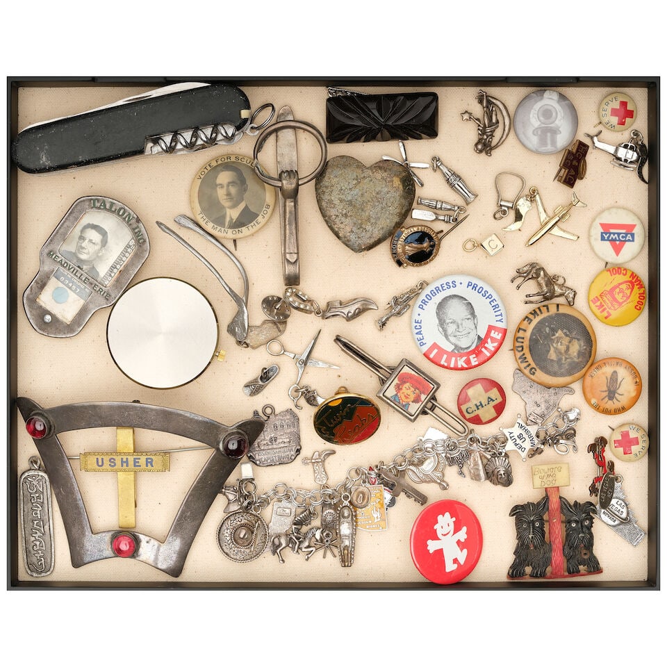 A CURATED BOX OF AMERICANA PINS, JEWELRY, AND ACCESSORIES: A CURATED BOX OF AMERICANA PINS, JEWELRY, AND ACCESSORIES Including a Southwestern charm bracelet, a Swiss Army knife, and a Tiffany & Co. metal travel alarm clock. height of box 2in; width 11 1/2in;