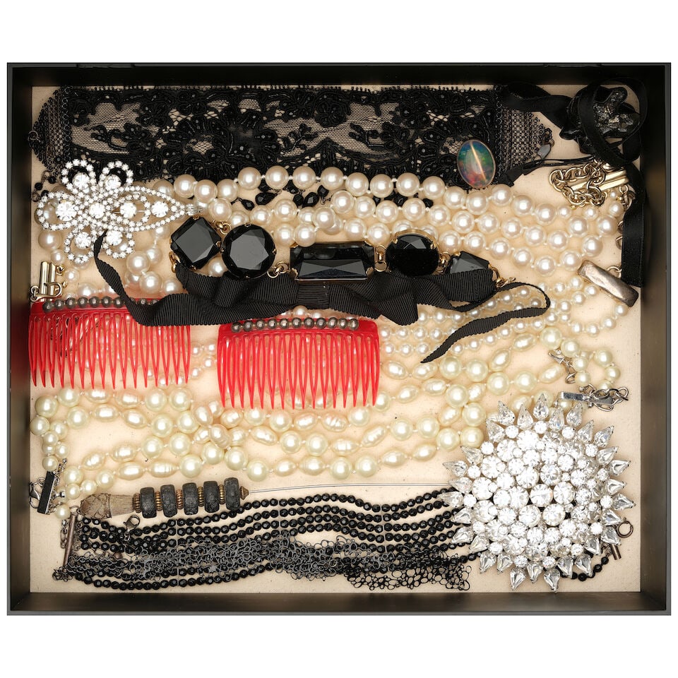 A BOX OF CURATED VICTORIAN INSPIRED JEWELRY AND ACCESSORIES: A BOX OF CURATED VICTORIAN INSPIRED JEWELRY AND ACCESSORIES Including a pair of red beaded combs, a black lace chocker, a hat pin, and a large faux jewel brooch. box height 4in; width 14in; depth 12in