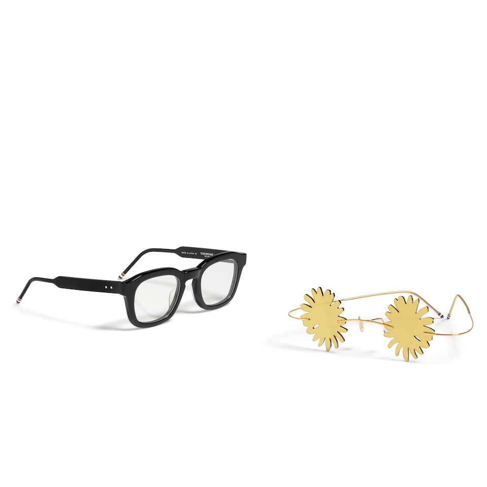 TWO PAIRS OF THOM BROWNE EYEGLASSES: TWO PAIRS OF THOM BROWNE EYEGLASSES Comprising a pair of TBX412-48-01 eyeglasses in black and a pair of yellow reflective 'flower' sunglasses. This lot is subject to the following lot symbols: