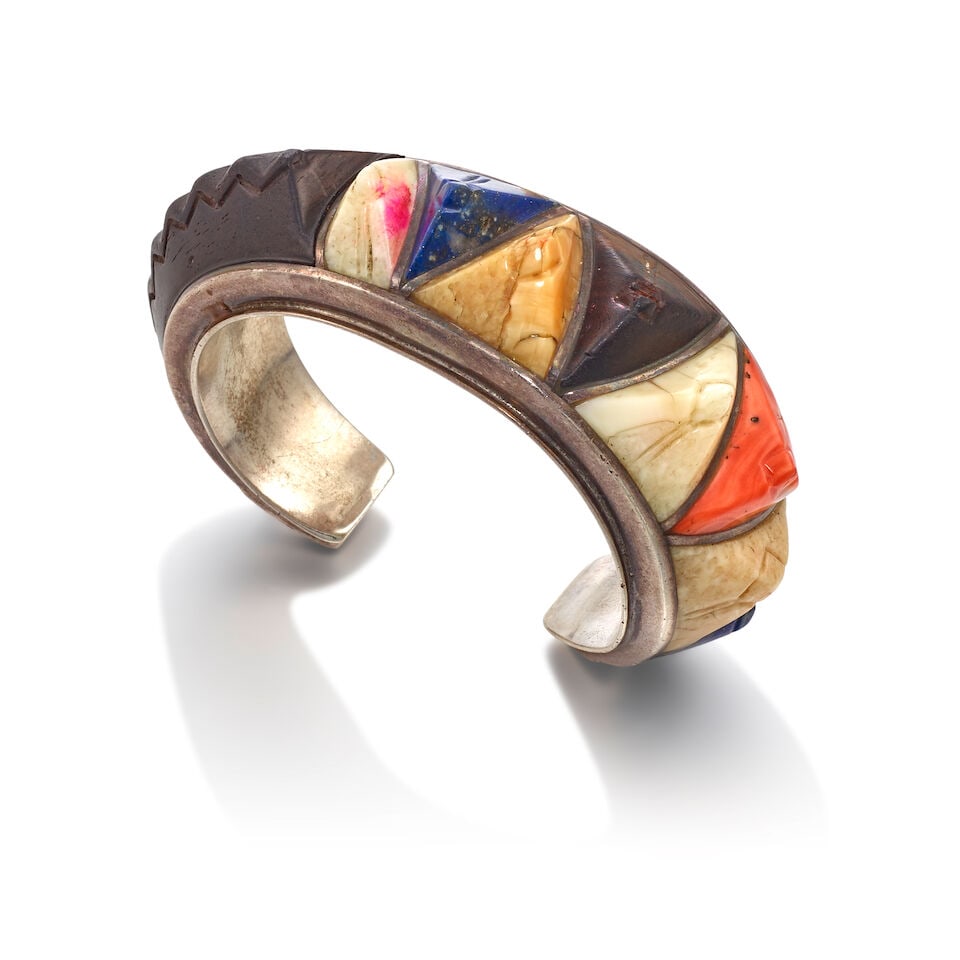 EVELYN (EVELI) SABATIE (ALGERIAN/MOROCCAN BORN 1940): SILVER AND CARVED MULTI-STONE INLAY CUFF B...: EVELYN (EVELI) SABATIE (ALGERIAN/MOROCCAN BORN 1940): SILVER AND CARVED MULTI-STONE INLAY CUFF BRACELET The interior signed Eveli. Footnotes: Working and living on Hopi from 1968 to 1972, Eveli