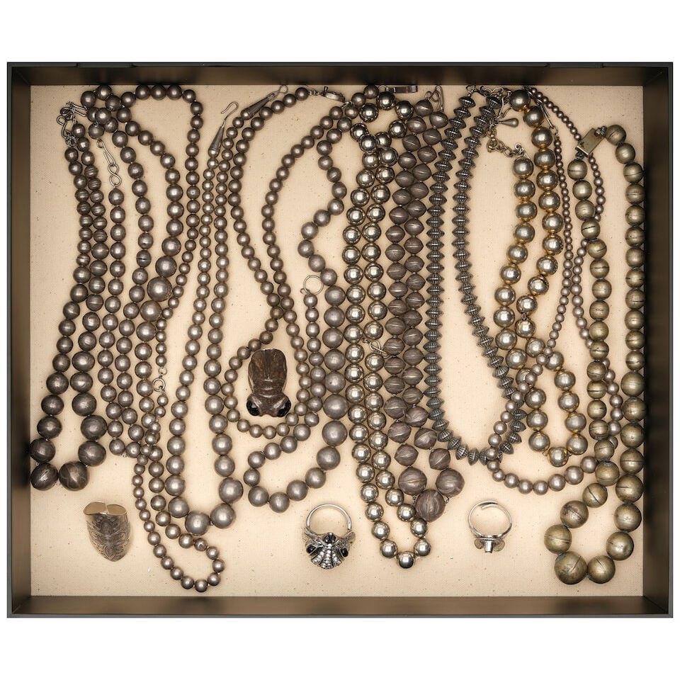 A CURATED BOX OF SILVER BEADED NECKLACES AND RINGS: A CURATED BOX OF SILVER BEADED NECKLACES AND RINGS Including a silver adjustable cowboy hat ring, a sterling silver bright-cut ring, and a silver bug ring with inset black glass eyes. height of box