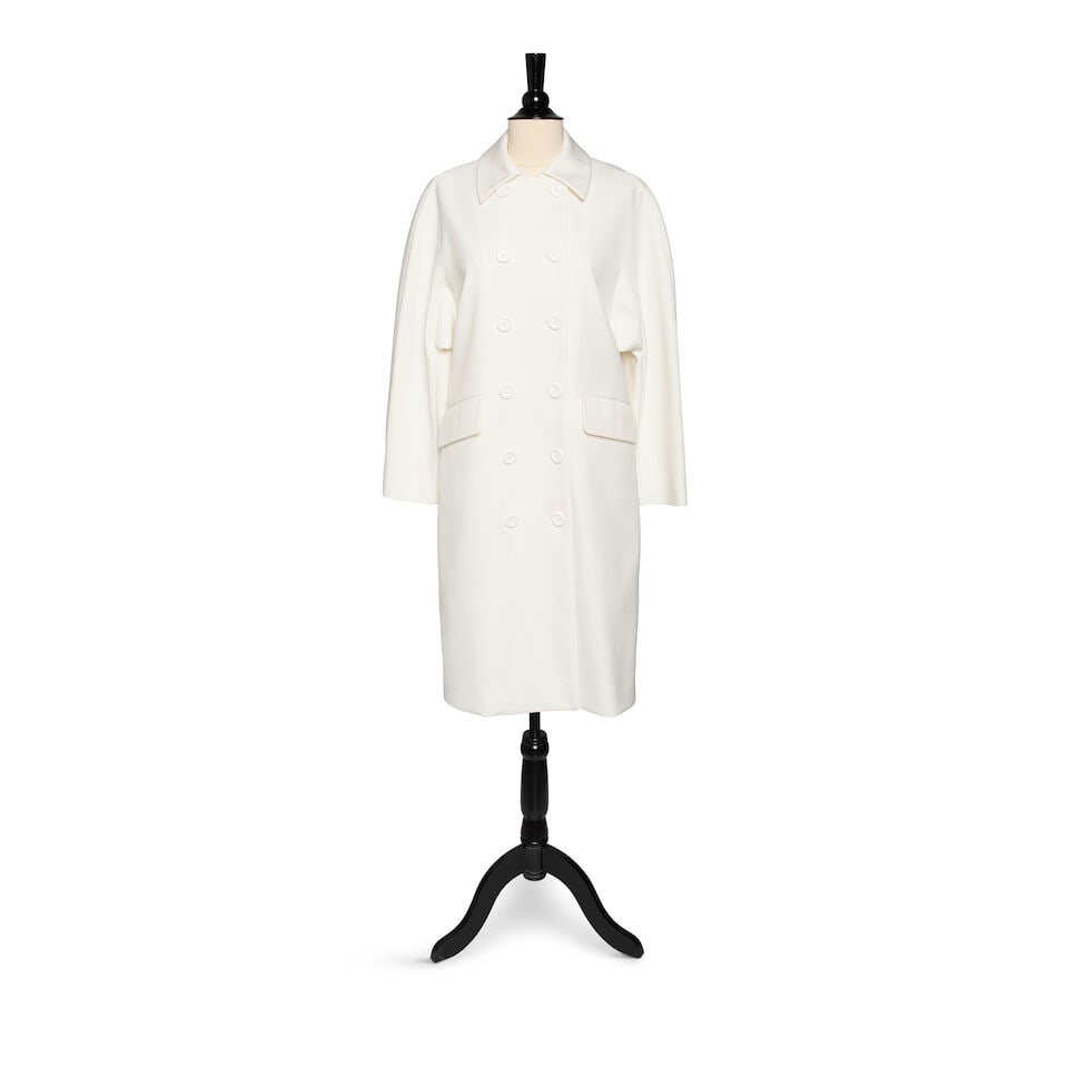 A SCREEN WORN MIU MIU WHITE BUTTON-DOWN COLLARED COAT: A SCREEN WORN MIU MIU WHITE BUTTON-DOWN COLLARED COAT Marked size 40. Footnotes: Worn in the film Mack & Rita, 2022. This lot is subject to the following lot symbols: ¤ ¤ Unless indicated