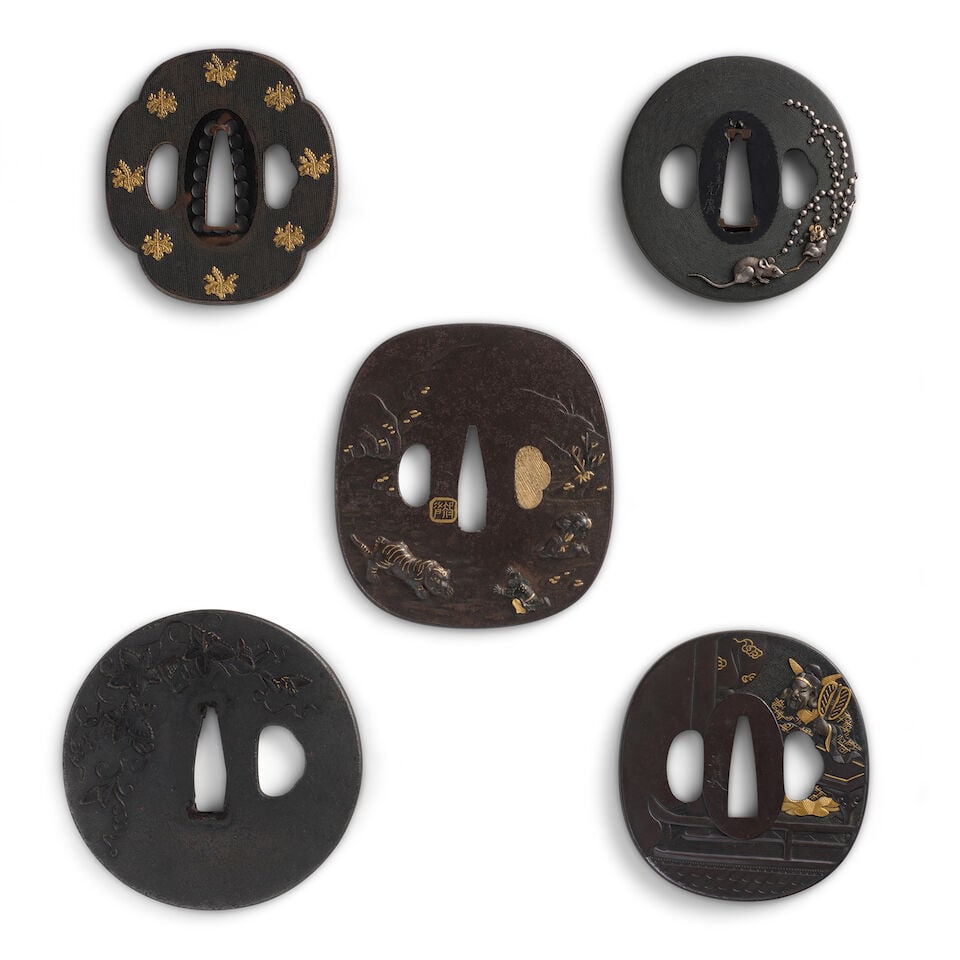 THREE SHAKUDŌ TSUBA (HAND GUARDS) AND TWO IRON TSUBA Edo period (1615-1868), 19th century (5): THREE SHAKUDŌ TSUBA (HAND GUARDS) AND TWO IRON TSUBA Edo period (1615-1868), 19th century Comprising a mokkō shakudō nanakoji tsuba inlaid in gold with 15 kirimon; an almost circular sh