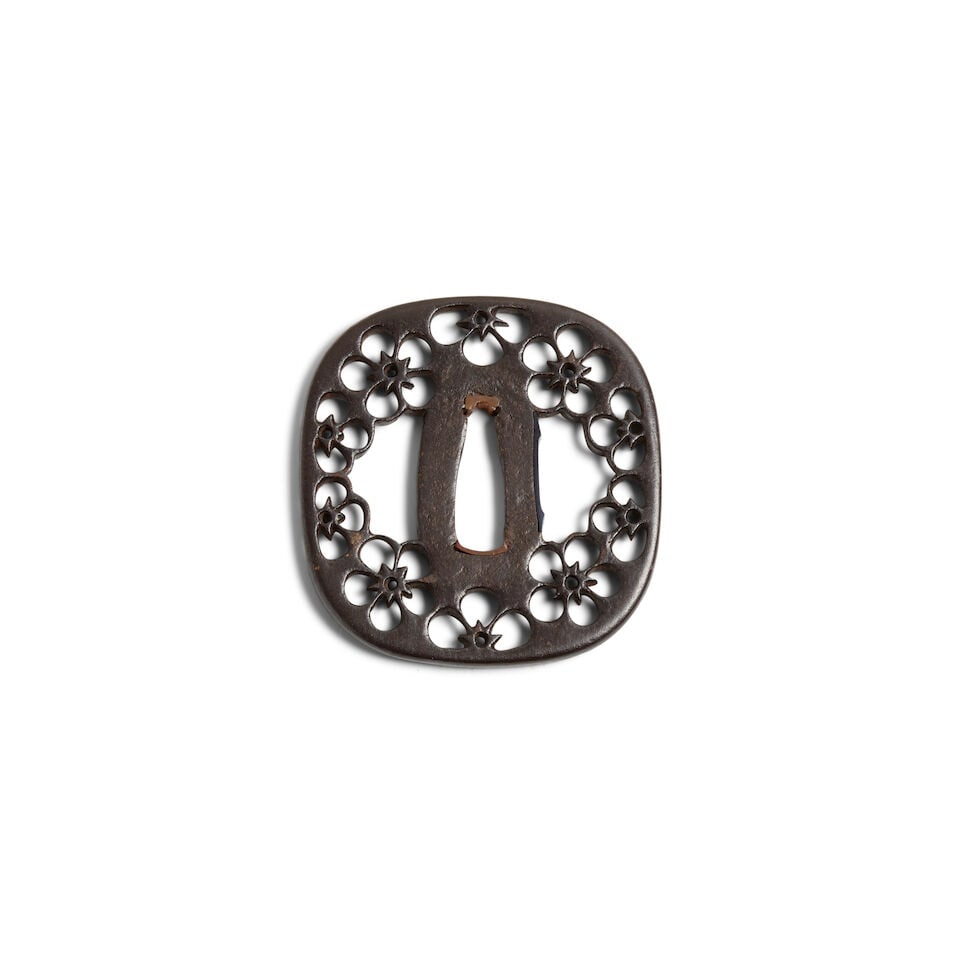 ATTRIBUTED TO HAYASHI MATASHICHI (1613-1699) An Iron Sukashi Tsuba (Hand Guard) Edo period (1615...: ATTRIBUTED TO HAYASHI MATASHICHI (1613-1699) An Iron Sukashi Tsuba (Hand Guard) Edo period (1615-1868), 17th century Of rounded rectangular form with a rounded rim, pierced with cherry blossoms; with 