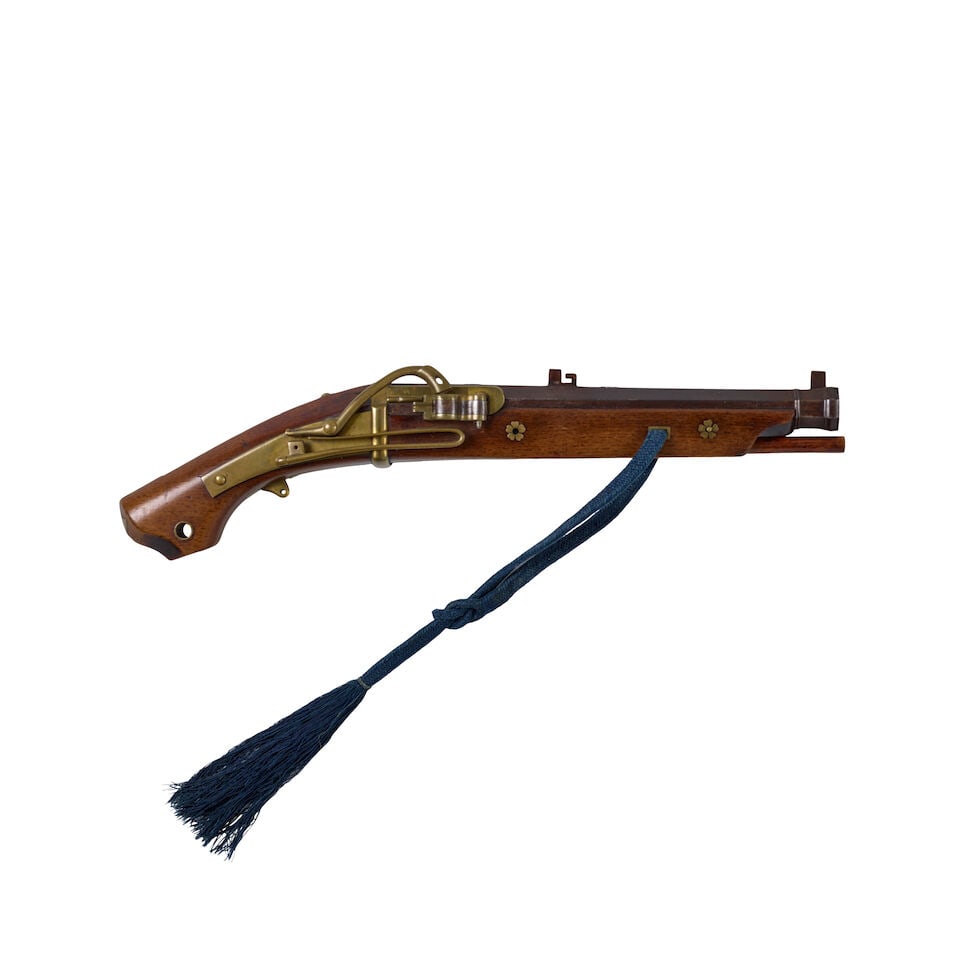 A TANZUTSU (MATCHLOCK PISTOL) Edo period (1615-1868), 18th/19th century: A TANZUTSU (MATCHLOCK PISTOL) Edo period (1615-1868), 18th/19th century The octagonal barrel decorated with silver family crests of takanoha (hawk feather) design set into a wood stock with