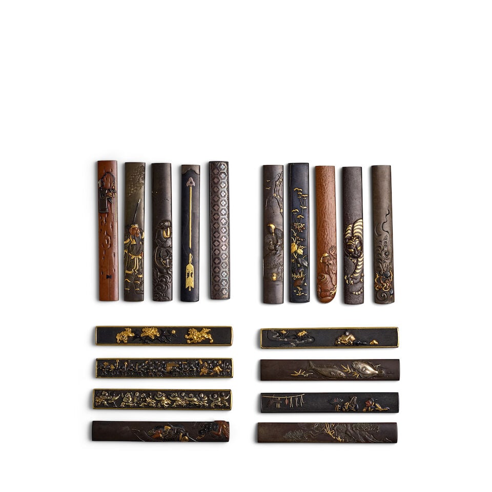 18 MIXED-METAL KOZUKA (KNIFE HANDLES) Edo period (1615-1868), 18th/19th century (18): 18 MIXED-METAL KOZUKA (KNIFE HANDLES) Edo period (1615-1868), 18th/19th century Comprising a shibuichi migakiji kozukachiseled in relief and with details in gold and silverdepicting two fish, the reve