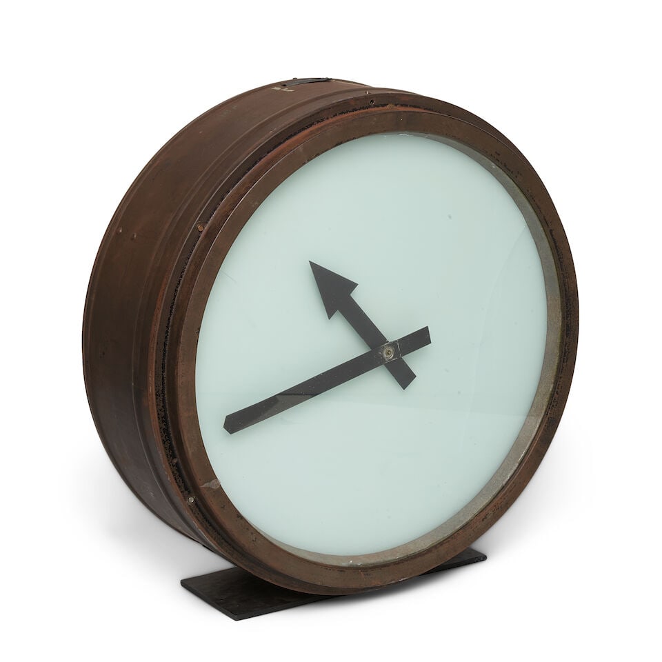 A LARGE METAL CLOCK: A LARGE METAL CLOCK diameter 30 1/2in Footnotes: From Diane Keaton's library in her Sullivan Canyon home. This lot is subject to the following lot symbols: ¤ ¤ Unless indicated by the ¤