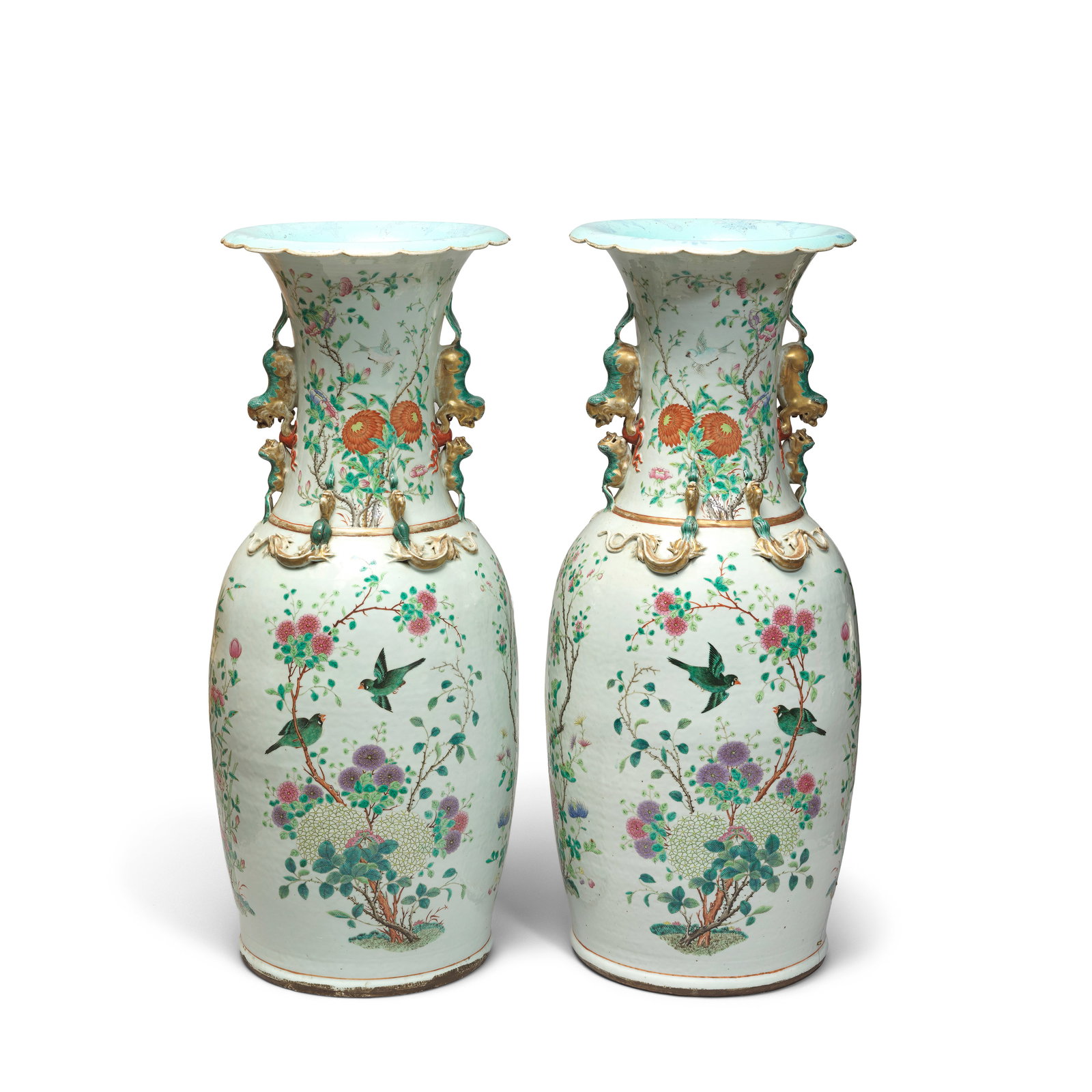 A LARGE PAIR OF FAMILLE ROSE VASES 19th century (2): A LARGE PAIR OF FAMILLE ROSE VASES 19th century Each sturdily potted of baluster form surmounted by tall waisted cylindrical necks with flaring foliate rims, flanked by pairs of confronting Buddhist-l