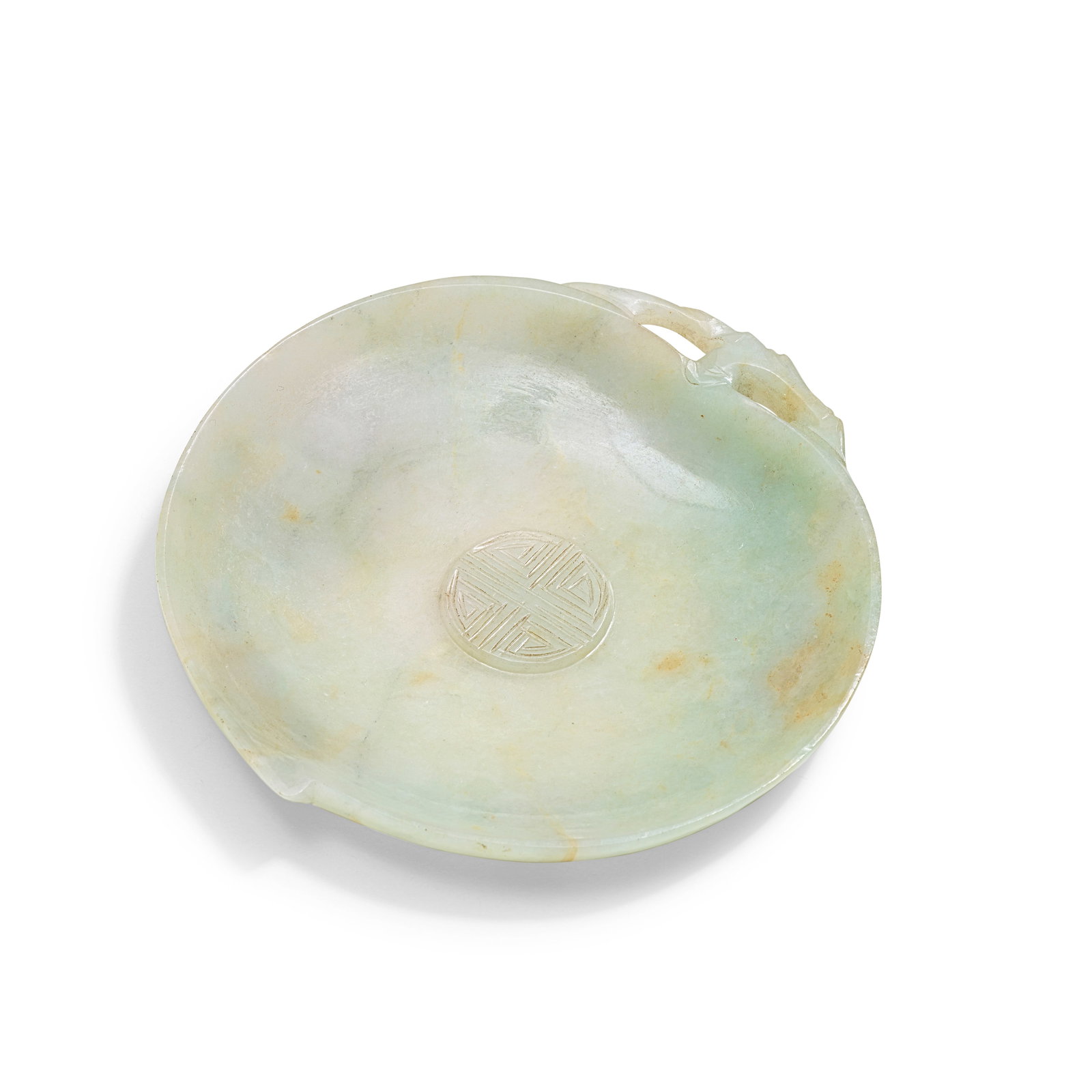 A JADEITE 'LONGEVITY' DISH Qing Dynasty: A JADEITE 'LONGEVITY' DISH Qing Dynasty The shallow dish carved in the form of a peach, the interior in relief with a shou medallion, the exterior carved with trailing leaves issuing from the stem at 