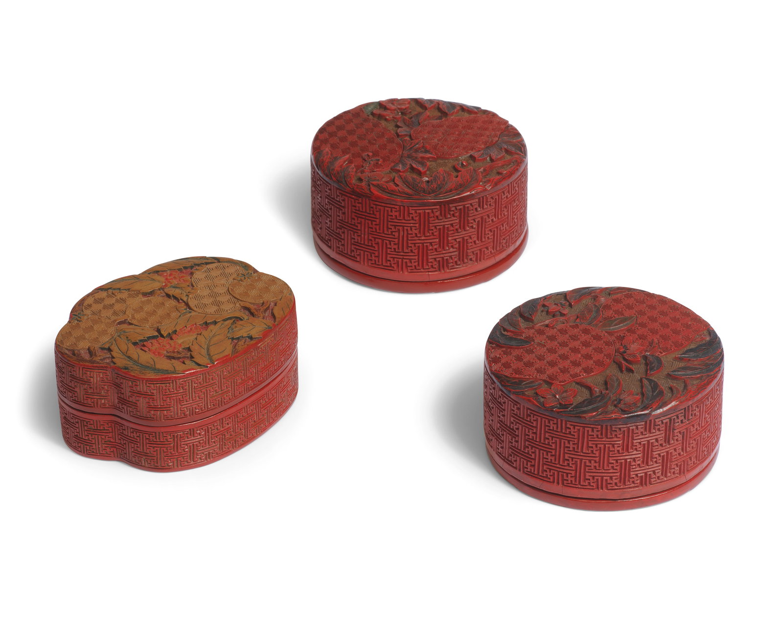 A POLYCHROME LACQUER BOX AND COVER AND A PAIR OF POLYCHROME LACQUER BOXES AND COVERS 18th centur...: A POLYCHROME LACQUER BOX AND COVER AND A PAIR OF POLYCHROME LACQUER BOXES AND COVERS 18th century Comprising: a pair of circular boxes and covers, one carved to the cover with two large peaches on lea