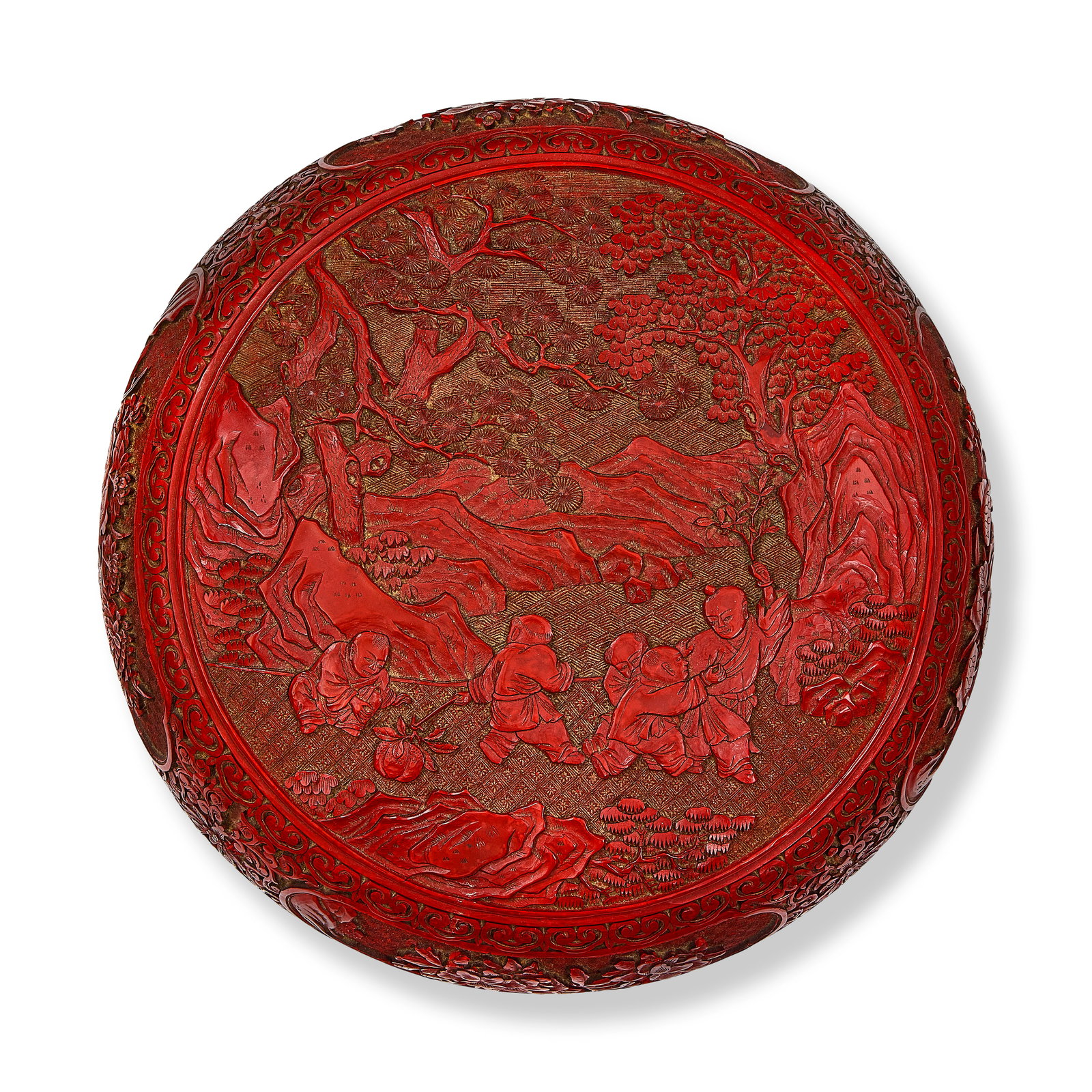 A CARVED CINNABAR LACQUER CIRCULAR 'BOYS' BOX AND COVER 18th century (2): A CARVED CINNABAR LACQUER CIRCULAR 'BOYS' BOX AND COVER 18th century The cover carved with a central panel depicting a group of five boys at play in a landscape of pine, paulownia trees and rockwork, 