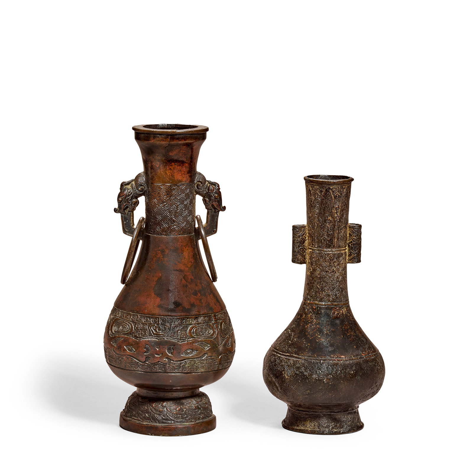 TWO ARCHAISTIC BRONZE PEAR-SHAPED VASES Yuan/Ming Dynasty (2): TWO ARCHAISTIC BRONZE PEAR-SHAPED VASES Yuan/Ming Dynasty One set on a domed foot, the pear-shaped body rising to a tall neck with everted rim, cast with bands of waves, archaistic motifs and key-fret
