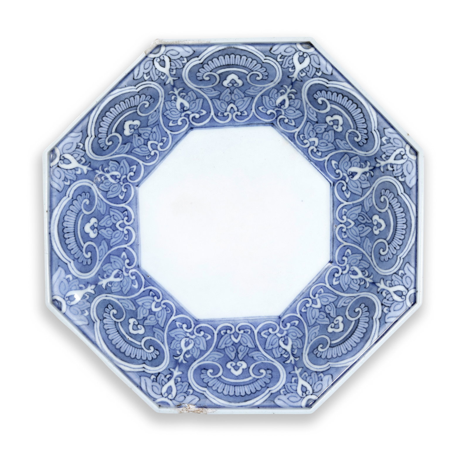 A BLUE AND WHITE OCTAGONAL NABESHIMA DISH Edo Period, 18th century: A BLUE AND WHITE OCTAGONAL NABESHIMA DISH Edo Period, 18th century Finely potted on a tall straight foot with curving sides rising to a flaring lipped mouth rim, painted on the interior of the cavetto