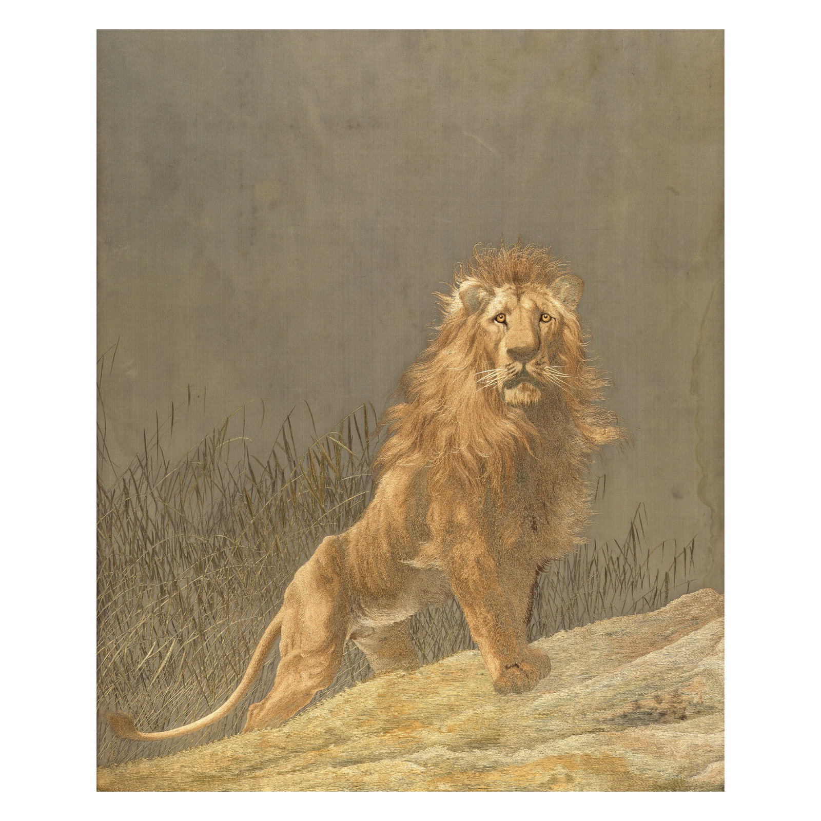 AN EMBROIDERED SILK 'LION' PANEL Meiji period: AN EMBROIDERED SILK 'LION' PANEL Meiji period Finely worked in a variety of stitches in shaded tones with a lion standing alert on a grassy slope before dense reeds, against a grey silk ground, framed