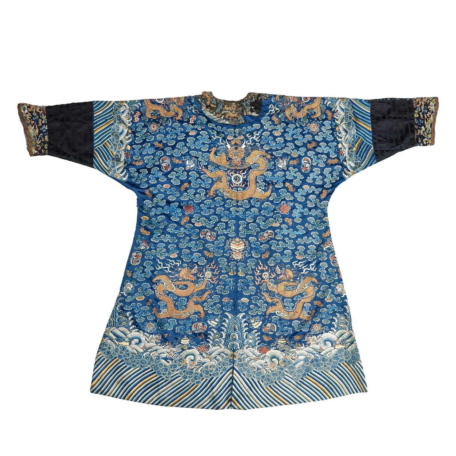 A BLUE GROUND EMBROIDERED DRAGON ROBE 19th century: A BLUE GROUND EMBROIDERED DRAGON ROBE 19th century Woven in couched gold thread with writhing dragons in pursuit of the flaming pearl amongst scattered Buddhist and auspicious emblems and dense ruyi f