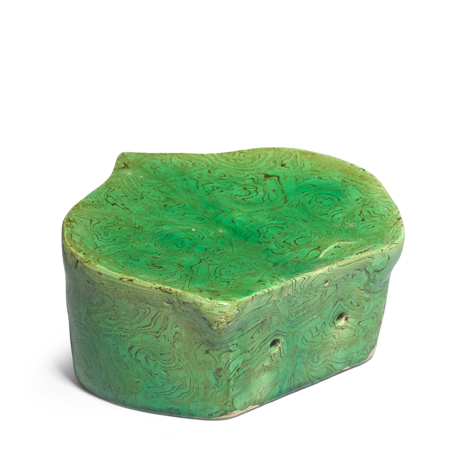 A GREEN-GLAZED MARBLED RUYI-SHAPED PILLOW Song/Jin Dynasty: A GREEN-GLAZED MARBLED RUYI-SHAPED PILLOW Song/Jin Dynasty The section of ruyi-head form, the red and buff clay marbled and covered overall with an apple-green glaze save for the base. 15cm (5 7/8in) 