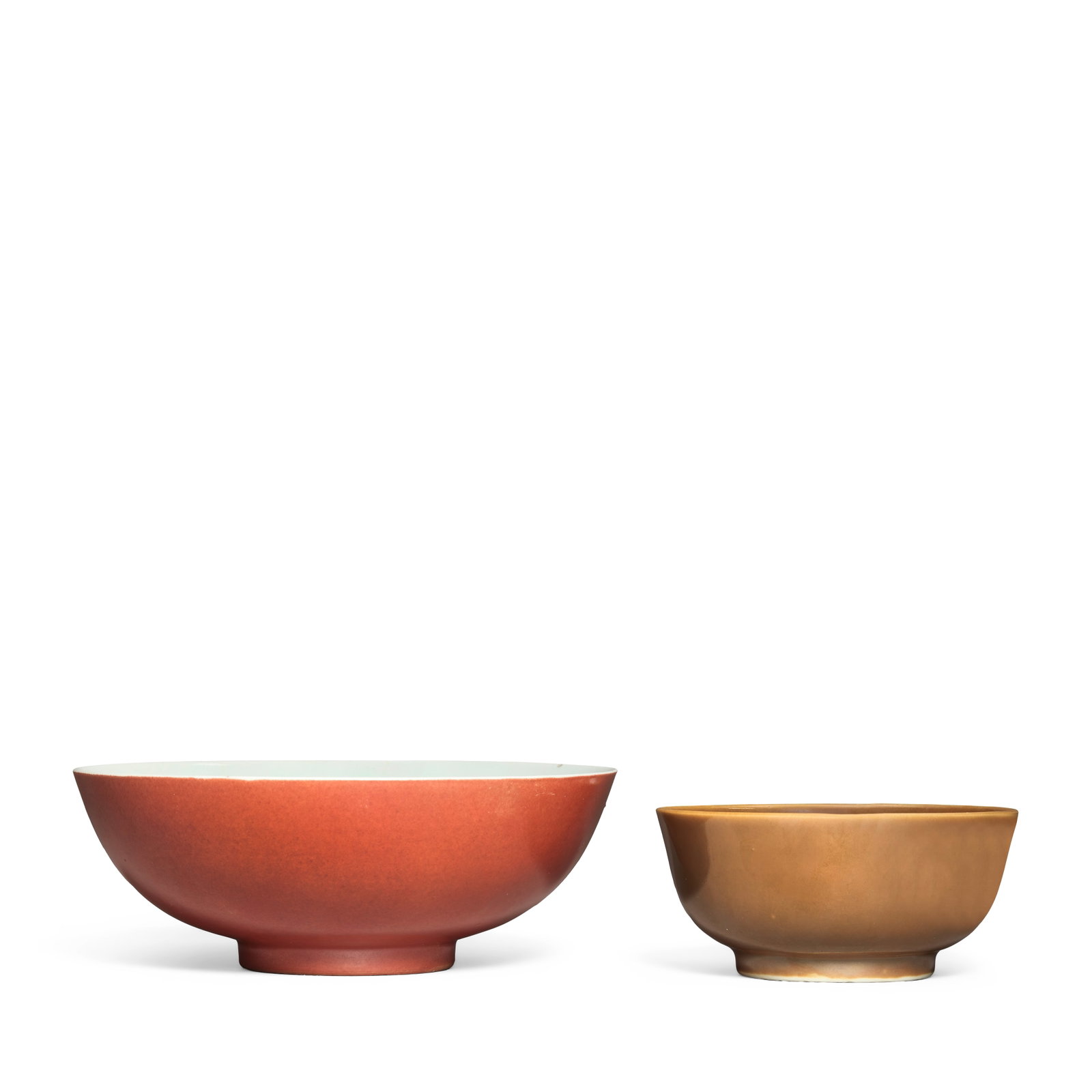 A CAFE-AU-LAIT GLAZED BOWL AND A CORAL ENAMELLED BOWL Qianlong (4): A CAFE-AU-LAIT GLAZED BOWL AND A CORAL ENAMELLED BOWL Qianlong The first covered to the interior and exterior with a lustrous café-au-lait glaze, underglaze blue Qianlong minyao mark; the second 