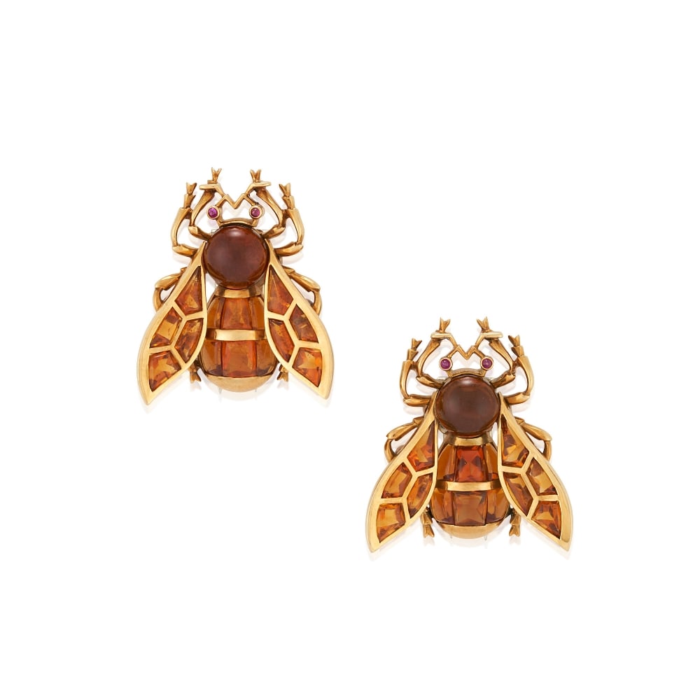 A PAIR OF 18K GOLD AND CITRINE BEE BROOCHES: A PAIR OF 18K GOLD AND CITRINE BEE BROOCHES The bees each set with calibré-cut, buff-top citrines, and citrine cabochons, with ruby cabochon eyes, weight 12.6 dwt, length 1 1/16 in. For further i