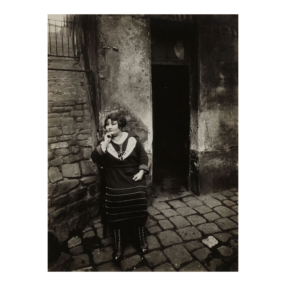 Eugène Atget (1857-1927); La Villette, rue Asselin, fille publique faisant le quart devant ... (1 of 2)