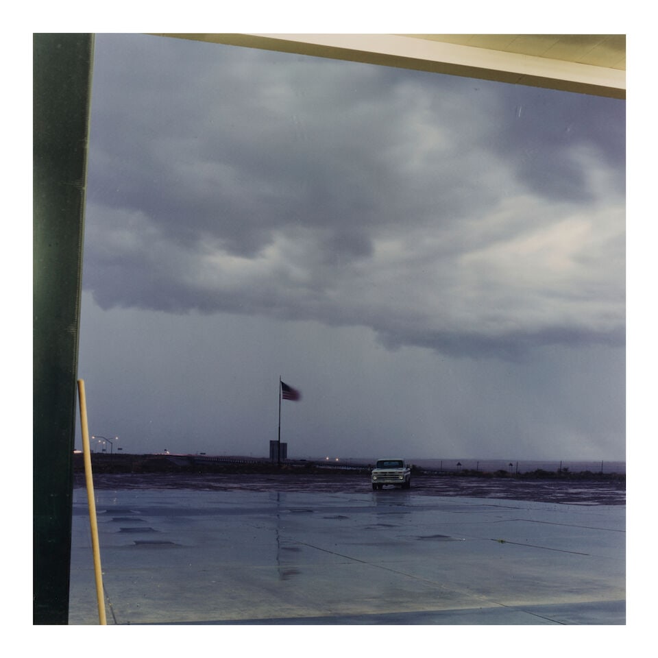 Jeff Brouws (born 1955); 'Storm, Truck, Flag, Holbrook, AZ' (from 'Highway Landscape');: Jeff Brouws (born 1955) 'Storm, Truck, Flag, Holbrook, AZ' (from 'Highway Landscape'), 1992 Chromogenic print; signed, titled, dated, annotated, and editioned '3/20' in ink on the reverse, framed, a R