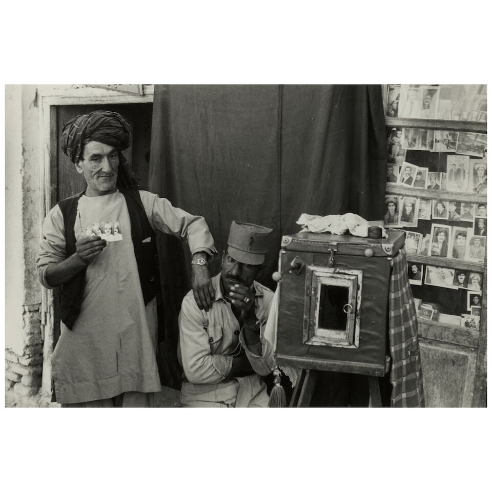 Elliott Erwitt (1928-2023); Photographer, Herat, Afghanistan;: Elliott Erwitt (1928-2023) Photographer, Herat, Afghanistan, 1977 Gelatin silver print; signed in pencil on the reverse, framed. 8 x 11 7/8 in. (20.2 x 30.1 cm) sheet 11 x 13 7/8 in. (27.9 x 35.2 cm) 