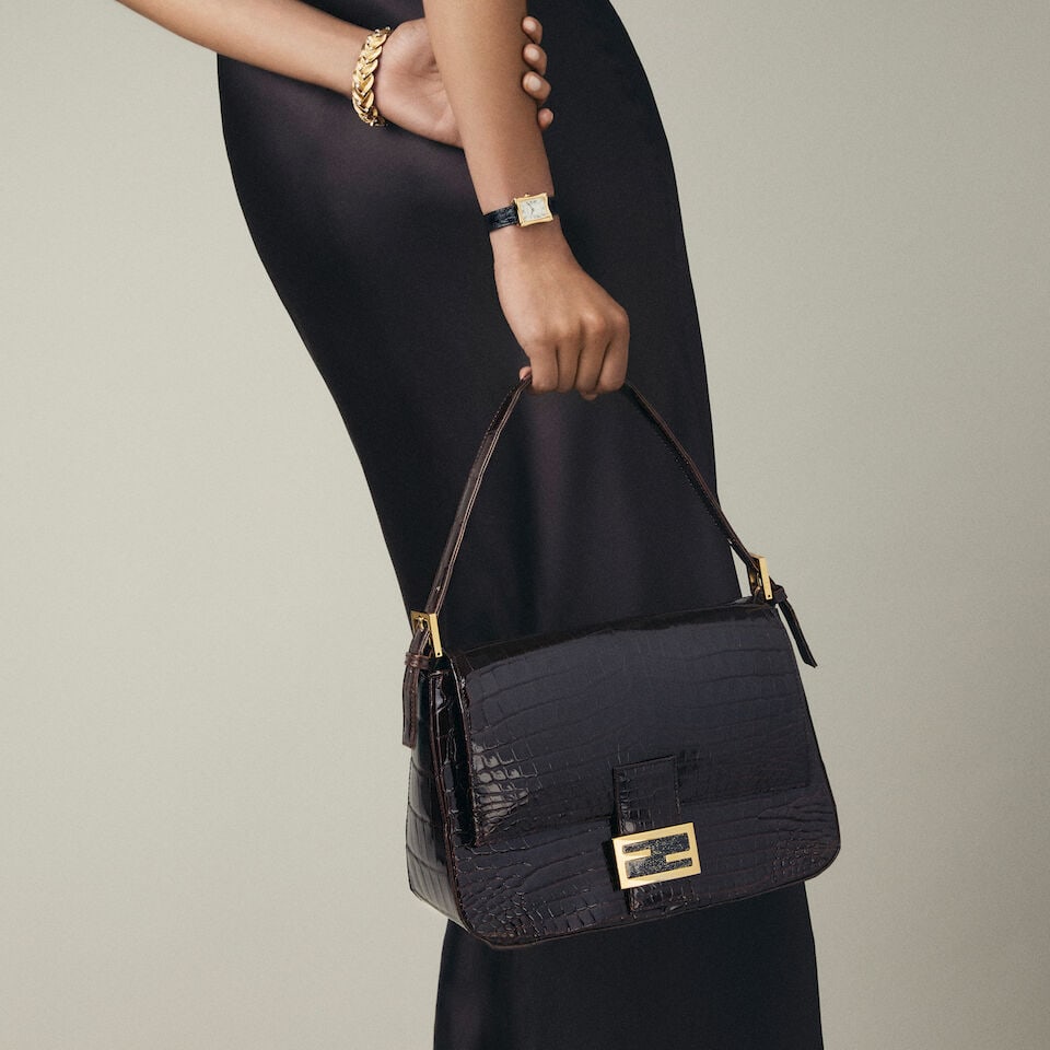 Fendi: a Shiny Brown Crocodile Mamma Baguette Bag Late 1990s or early 2000s (includes dust bag): Fendi: a Shiny Brown Crocodile Mamma Baguette Bag Late 1990s or early 2000s Top handle with gold and blue glitter enamelled clasp, purple satin interior Condition Grade B 28cm wide, 18cm high, 12cm
