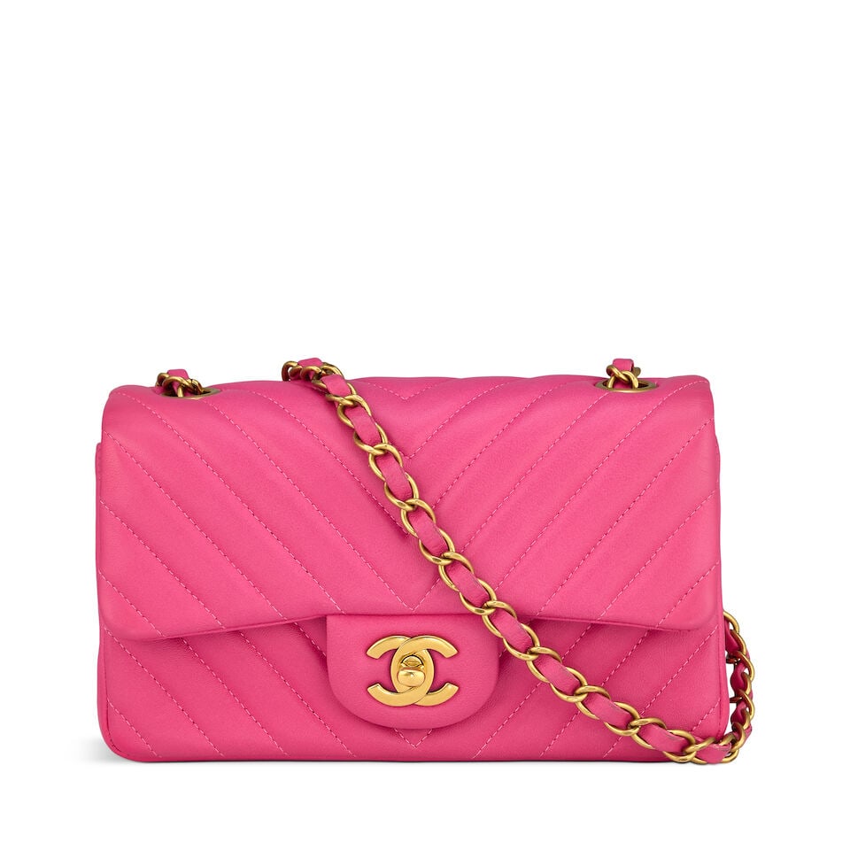 Chanel: a Pink Chevron Quilted Lambskin Mini Flap Bag 2015-16 (includes serial sticker): Chanel: a Pink Chevron Quilted Lambskin Mini Flap Bag 2015-16 Creative Director: Karl Lagerfeld Chevron quilted lambskin with matte gold tone hardware Condition Grade B+ 20cm wide, 12cm high, 7cm