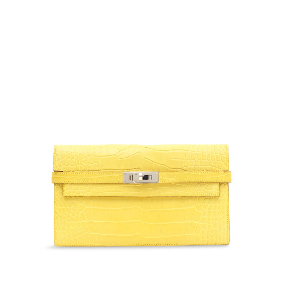 Hermès: a Mimosa Matte Alligator Kelly Long Wallet 2019 (includes dust bag): Hermès: a Mimosa Matte Alligator Kelly Long Wallet 2019 Palladium hardware Condition Grade B+ 20cm wide, 12cm high includes dust bag Footnotes: Alligator mississippiensis, Annexe CITES II-B This