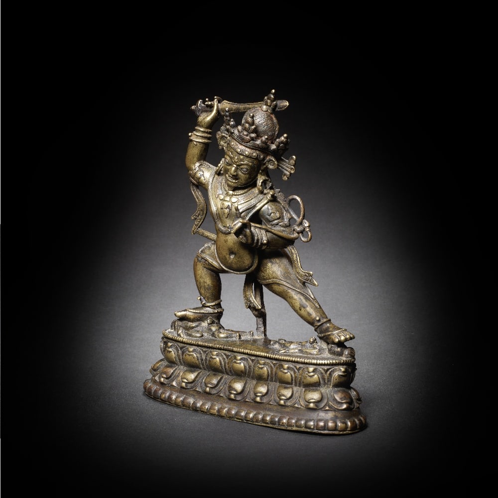 A RARE SILVER AND COPPER-INLAID BRONZE FIGURE OF ARYA ACHALA: A RARE SILVER AND COPPER-INLAID BRONZE FIGURE OF ARYA ACHALA Tibet, 13th century The deity cast standing in alidha-pratyalidha posture with the legs widely braced in a dynamic wrathful stance tramplin