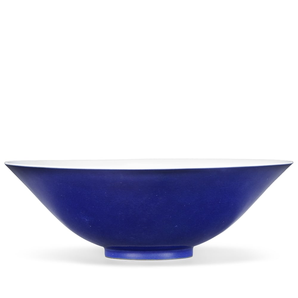 A BLUE-GLAZED BOWL Yongzheng six-character mark and of the period: A BLUE-GLAZED BOWL Yongzheng six-character mark and of the period Thinly potted with deep rounded sides rising from a short straight foot to a flaring mouth rim, the exterior covered in a lustrous Pru