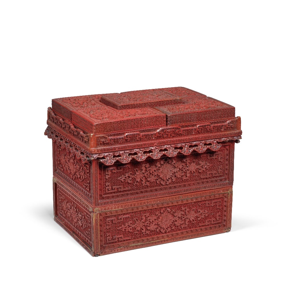 A RARE IMPERIAL CINNABAR LACQUER CARRIAGE BOX Qianlong (14): A RARE IMPERIAL CINNABAR LACQUER CARRIAGE BOX Qianlong Comprising a lower rectangular box with a drawer, beneath a second open box, surmounted by a rectangular section with pierced terrace and apron, 