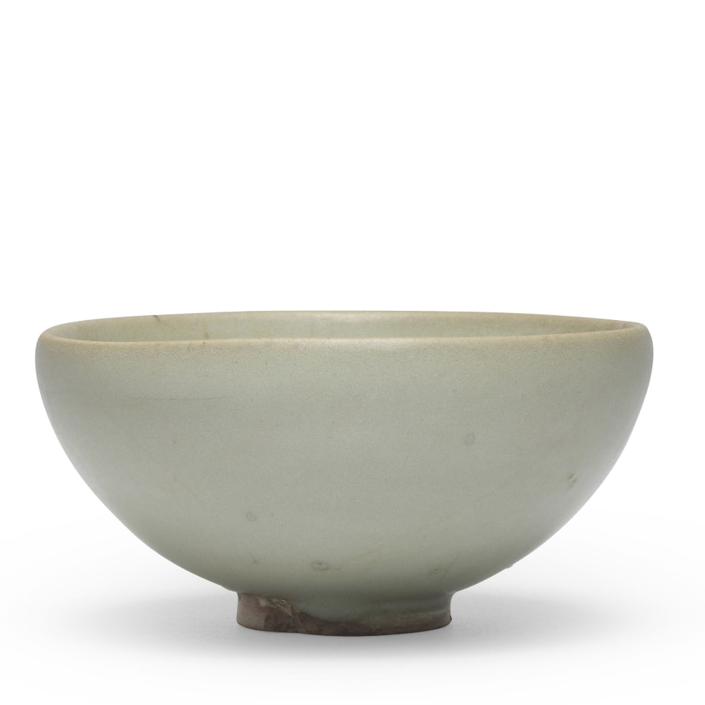 A JUNYAO 'BUBBLE' BOWL Song/Yuan Dynasty: A JUNYAO 'BUBBLE' BOWL Song/Yuan Dynasty The deep rounded sides covered in a thick glaze of greyish-green tone stopping unevenly above the short foot and thinning to a mushroom-grey tone at the mouth 