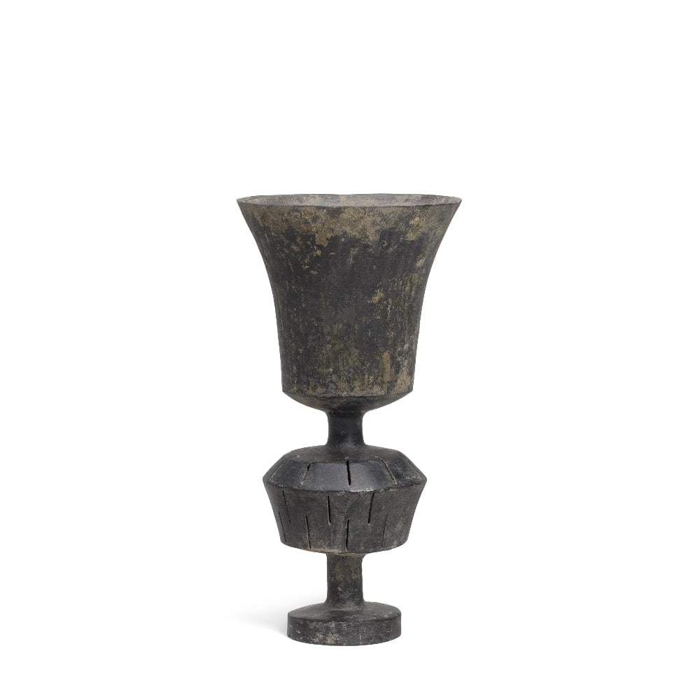 A BURNISHED BLACK POTTERY STEM CUP Neolithic period, Longshan culture, circa 2500-2000 BC: A BURNISHED BLACK POTTERY STEM CUP Neolithic period, Longshan culture, circa 2500-2000 BC Delicately potted with eggshell-thin sides, the U-shaped cup with a flaring rim supported on a stem with a glo