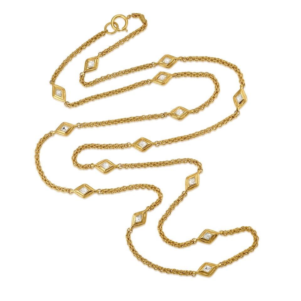 CHANEL: GOLD TONE SAUTOIR STATION NECKLACE 1970-1980: CHANEL: GOLD TONE SAUTOIR STATION NECKLACE 1970-1980 • Gold Tone Rope Chain with Glass Diamond Shape Station Detail • Spring Ring Closure • Measures 88 cm Drop For further