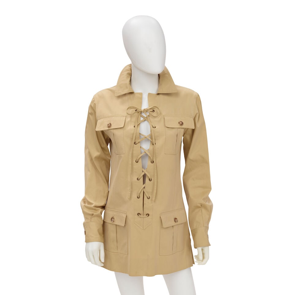 YVES SAINT LAURENT: SAFARI TUNIC 1968: YVES SAINT LAURENT: SAFARI TUNIC 1968 • No Marked Size | Fits Like 2/4 • Khaki Polished Cotton Exterior • Lace Up Grommet Closure For further information on this lot please visit Bon