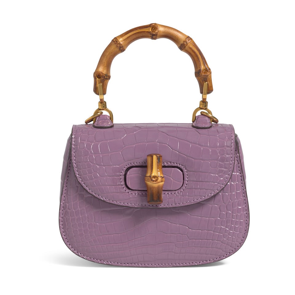 GUCCI: LILAC CROCODILE BAMBOO 1947 Fall 2021: GUCCI: LILAC CROCODILE BAMBOO 1947 Fall 2021 • Lilac Crocodile Exterior • Gold Tone Hardware • Bamboo Handle and Optional Shoulder Strap • Bamboo Twist Lock Closure • Lea