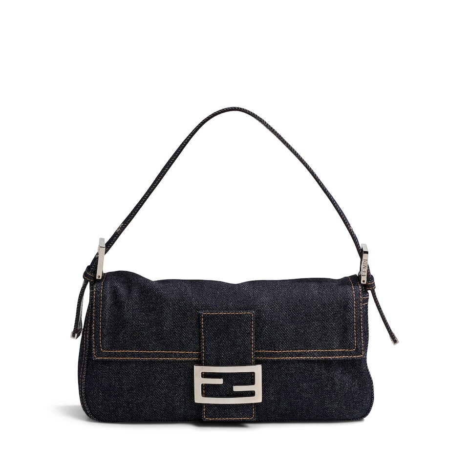 FENDI: BLUE DENIM BAGUETTE SHOULDER BAG 1998: FENDI: BLUE DENIM BAGUETTE SHOULDER BAG 1998 • Blue Denim Exterior with Contrast Stitch Detail • Silver Tone Hardware • Single Adjustable Shoulder Strap • Flap Closure with Fen