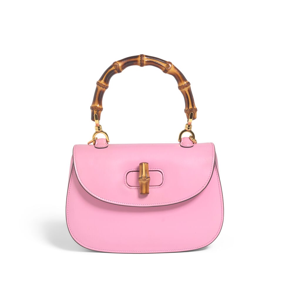GUCCI: PINK LEATHER SMALL BAMBOO 1947: GUCCI: PINK LEATHER SMALL BAMBOO 1947 • Pink Leather Exterior • Gold Tone Hardware • Bamboo Handle • Bamboo Turn Lock Closure • Linen Lined Interior with Pouch and Zipper