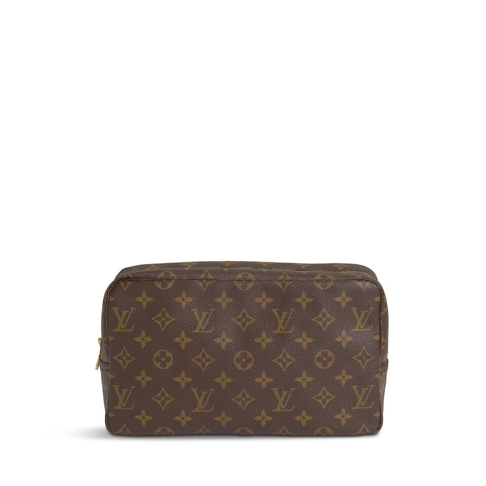 LOUIS VUITTON: MONOGRAM TROUSSE TOILETTE 28 1985: LOUIS VUITTON: MONOGRAM TROUSSE TOILETTE 28 1985 • Monogram Coated Canvas Exterior • Brass Tone Hardware • Zip Closure • Leather Lined Interior • Measures 28 cm x 17 cm