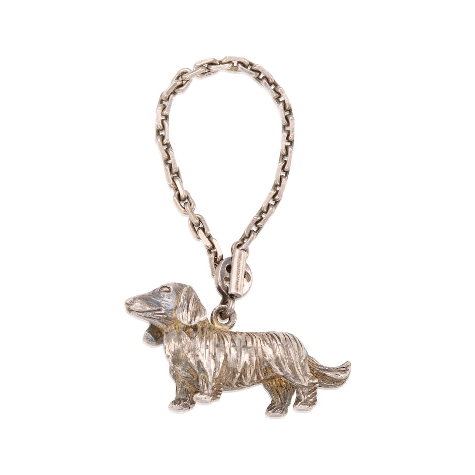 HERMÈS: SILVER DACHSHUND CHARM ON CHAIN: HERMÈS: SILVER DACHSHUND CHARM ON CHAIN • Marked Sterling Silver • Toggle Clasp Closure • Chain Length 12 cm | Pendant 5 cm x 2 cm For further information on this lot please vis