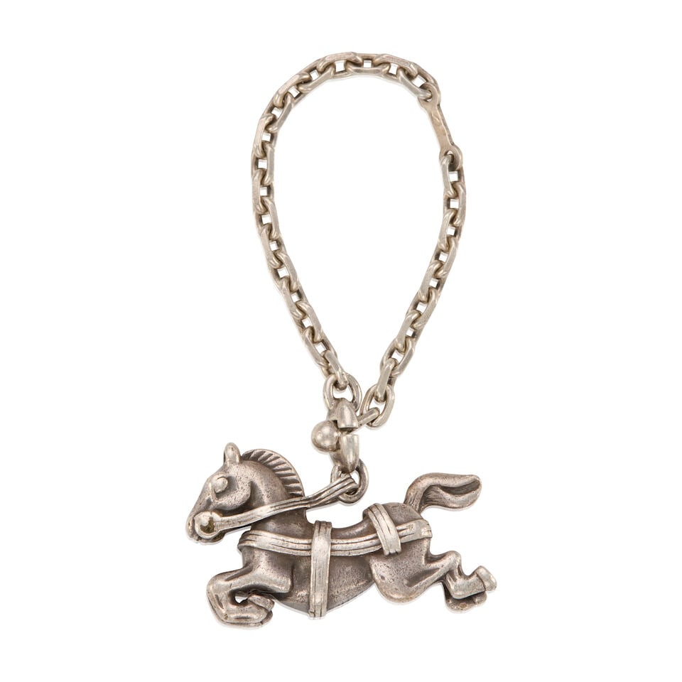 HERMÈS: SILVER CAROUSEL HORSE CHARM ON CHAIN: HERMÈS: SILVER CAROUSEL HORSE CHARM ON CHAIN • Marked 925 Sterling Silver • Toggle Clasp Closure • Chain Length 12 cm | Charm 4 cm x 2.5 cm For further information on this lot p