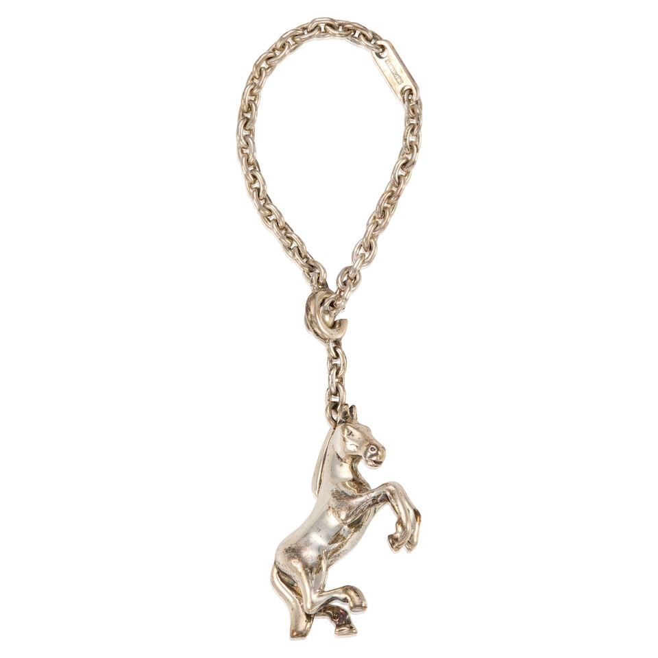 HERMÈS: SILVER L'ANNEE DE LA DANSE CHARM ON CHAIN 2007: HERMÈS: SILVER L'ANNEE DE LA DANSE CHARM ON CHAIN 2007 • Marked 925 Sterling Silver • Toggle Clasp Closure • Chain Length 12 cm | Charm 3 cm x 2 cm For further information on th