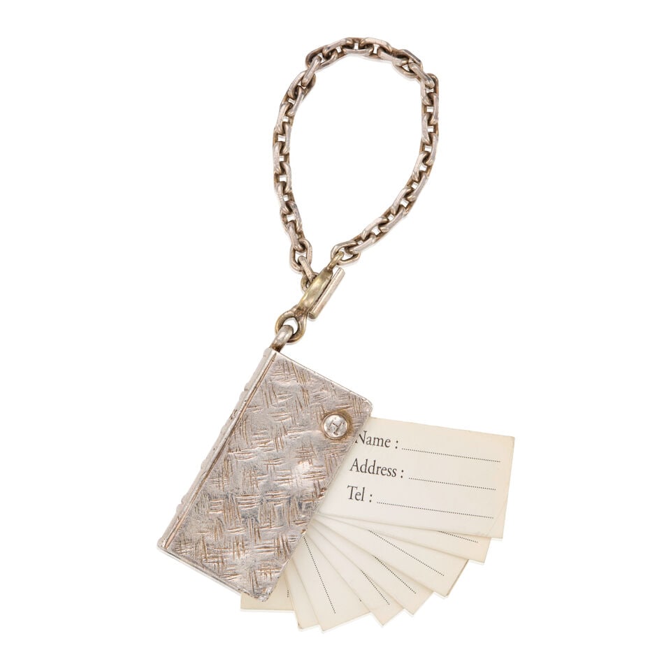 HERMÈS: SILVER ADDRESS BOOK CHARM ON CHAIN: HERMÈS: SILVER ADDRESS BOOK CHARM ON CHAIN • Marked 925 Sterling Silver • Writable Contact Detail Pull Out Tabs • Hermes Engraved on Spine • Toggle Clasp Closure • D