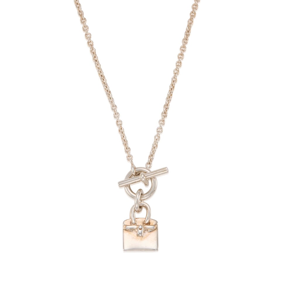 HERMÈS: SILVER MINI BIRKIN AMULETTE PENDANT NECKLACE: HERMÈS: SILVER MINI BIRKIN AMULETTE PENDANT NECKLACE • Marked 925 Sterling Silver • Toggle Clasp Closure • Chain Drop 20 cm | Pendant 1 cm x 1 cm For further information on this