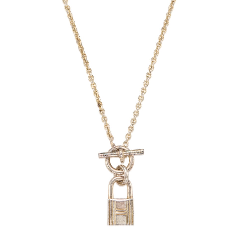 HERMÈS: SILVER MINI CADENA LOCK AMULETTE PENDANT NECKLACE: HERMÈS: SILVER MINI CADENA LOCK AMULETTE PENDANT NECKLACE • Marked 925 Sterling Silver • Toggle Clasp Closure • Chain Drop 20 cm | Pendant 1 cm x 2 cm For further information on
