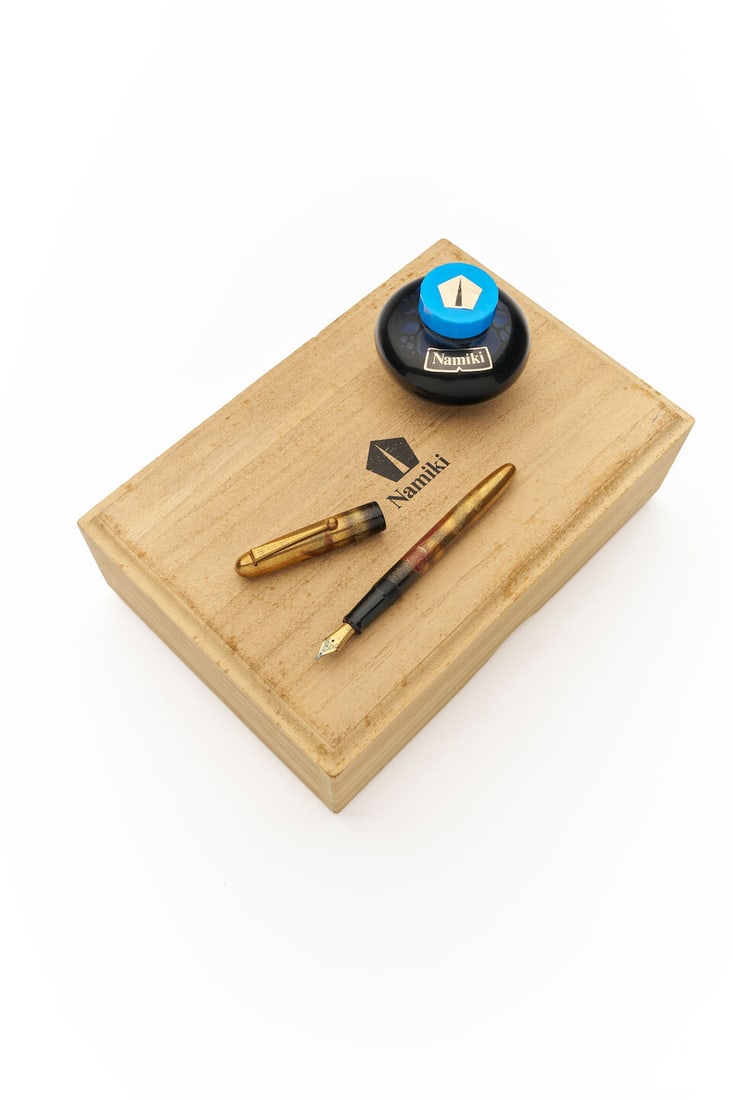 Namiki | Yukari Goldfish Maki-e fountain pen: Namiki | Yukari Goldfish Maki-e fountain pen Cap/Barrel/Clip: maki-e motifs, Goldfish with profusion of gold flakes. Nib: Medium 18K gold #10 nib, has been inked. Accompaniment: Maker's outer box, woo