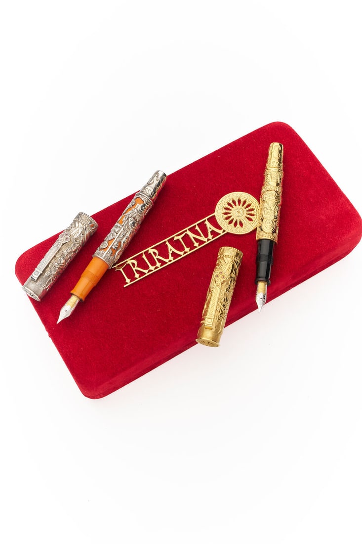 Omas | 'Trirantna' limited edition gold and silver writing instruments (2): Omas | 'Trirantna' limited edition gold and silver writing instruments Model: 'Trirantna' limited edition fountain pens gold 34/563, silver 34/2541. one example in yellow gold over black resin (repres