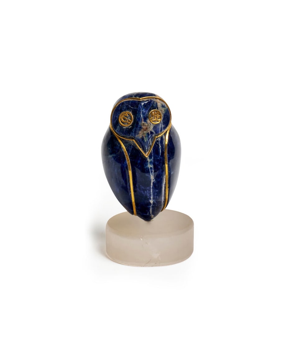 Ilias Lalaounis | Sodalite owl sculpture: Ilias Lalaounis | Sodalite owl sculpture The polished sodalite body applied with 18ct gold detail, raised on a circular base, signed with Ilias Lalaounis maker's mark, stamped 750 Greece A21, height: 
