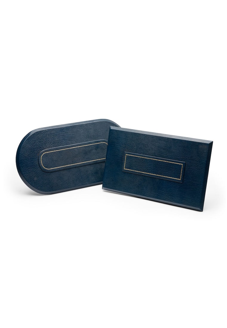 Asprey | two leather table seating planners (2): Asprey | two leather table seating planners each of blue leather, signed to the reverse Asprey, measuring 38.0 x 23.0cm, 44.5 x 24.5cm. (2) For further information on this lot please visit Bonhams.com