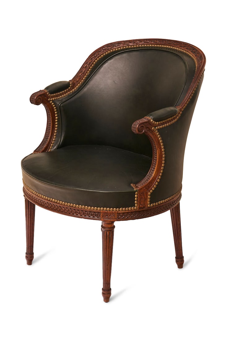 A Louis XVI fauteuil, stamped Henri Jacob, height: 81.0cm, depth: 55.0cm, width: 57.0cm: A Louis XVI fauteuil, stamped Henri Jacob, with laurel leaf carving to the crest, on fluted legs, with green leather upholstery, height: 81.0cm, depth: 55.0cm, width: 57.0cm Footnotes: Acquired throug